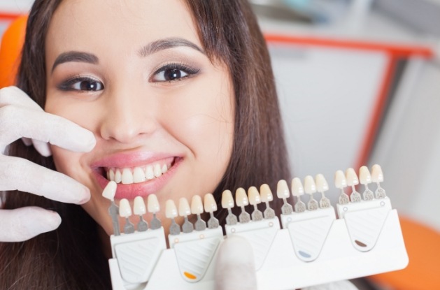 Woman trying on veneers from her cosmetic dentist in Westfield