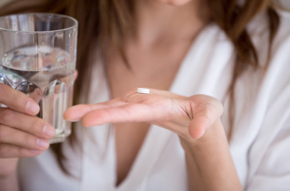 Person taking an antibiotic for gum disease 