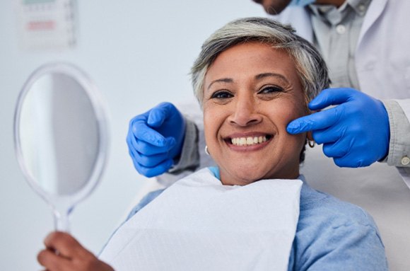 Woman smiling while sitting in treatment chair