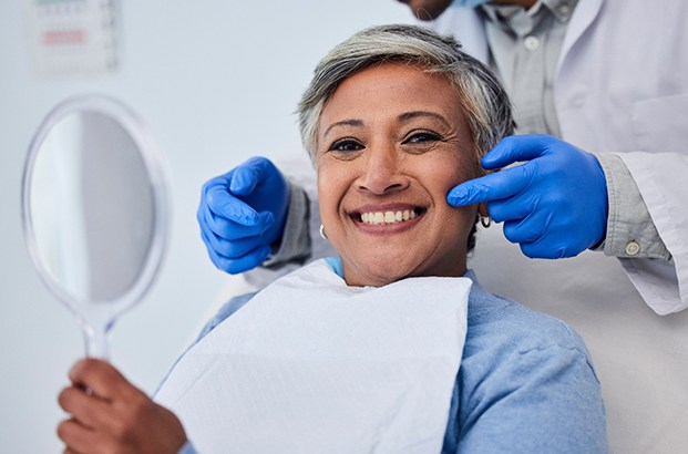 Dental forceps holding a tooth after tooth extractions in Westfield