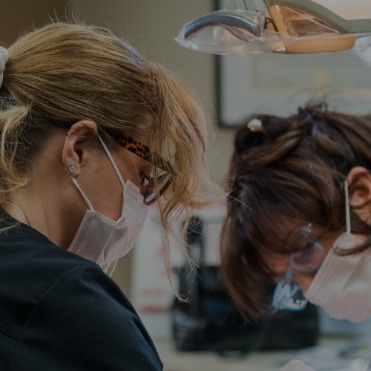 Dentist and dental team member treating a patient