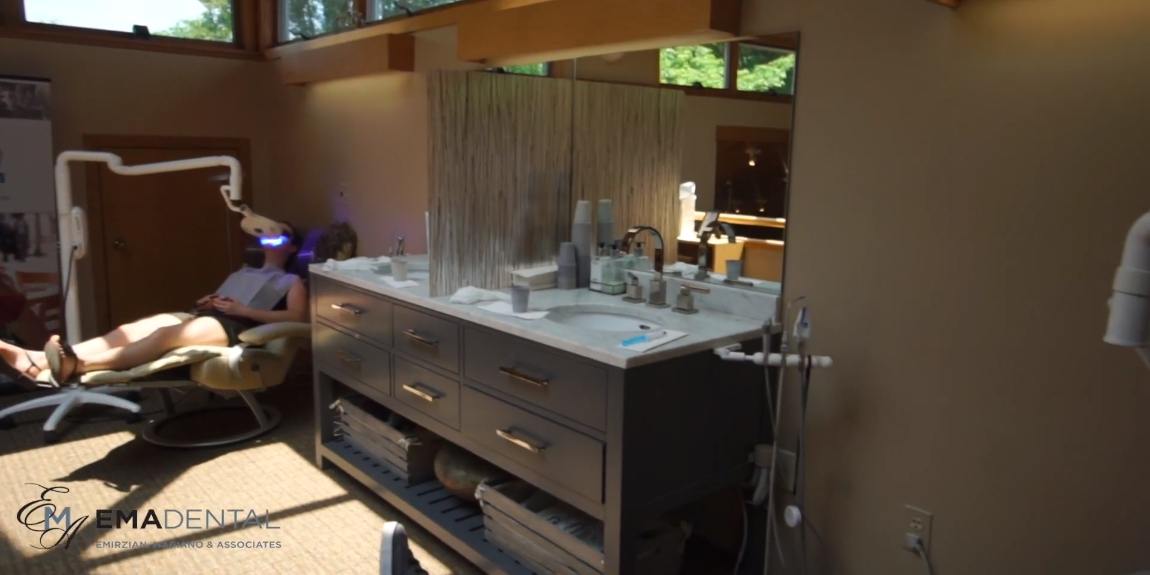 Woman having her teeth whitened in dental office