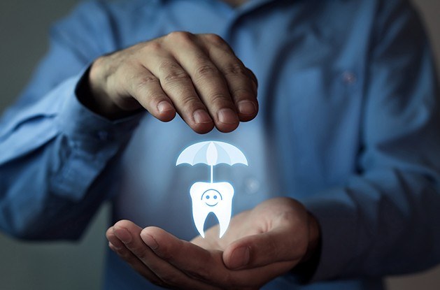 Man holding hologram of tooth under umbrella