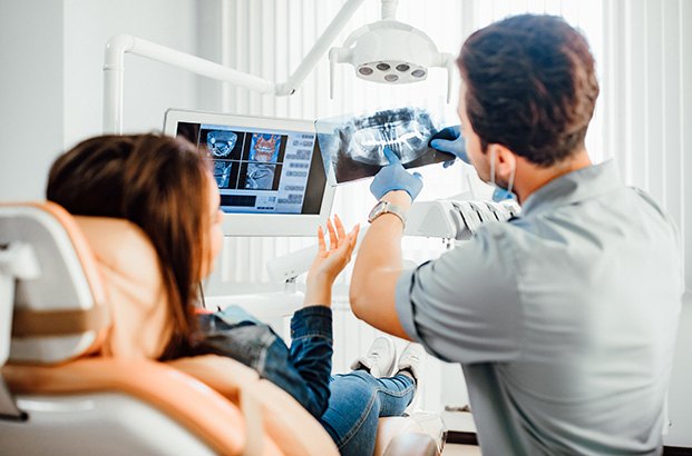 Dentist discussing X-rays with patient