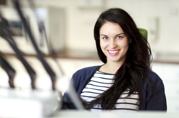 Woman in dental chair smiling during preventive dentistry visit