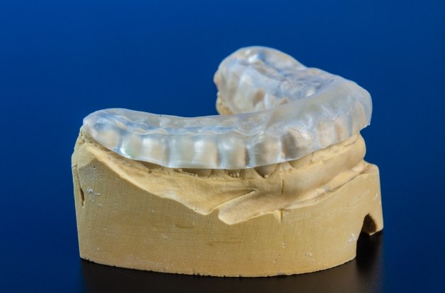 Model of row of teeth with clear nightguard