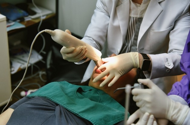 Dentist taking digital impressions of teeth