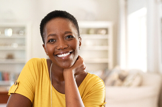 woman in yellow shirt smiling in living room